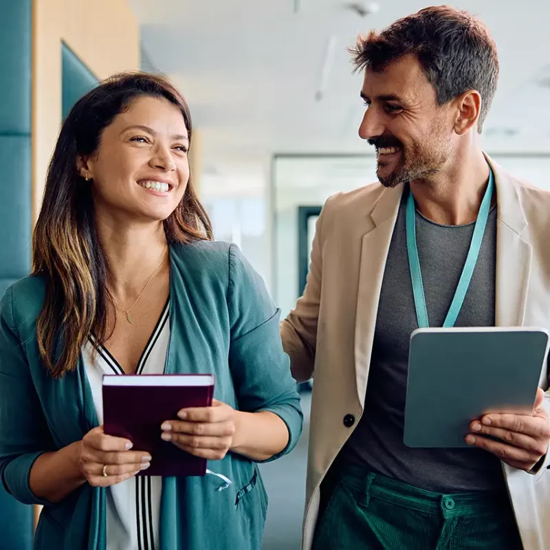 man and women standing talking and smiling