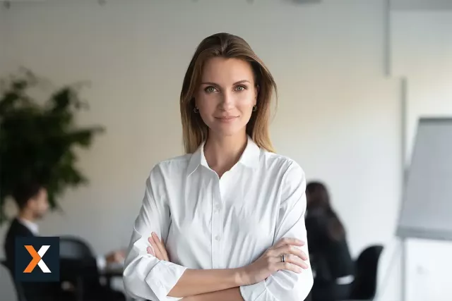 business women standing looking at camera with arms crossed