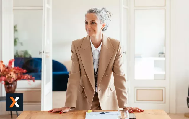 Woman in business suit standing smiling 