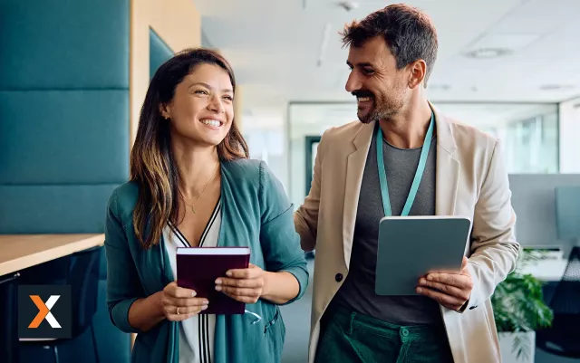 man and women standing talking and smiling