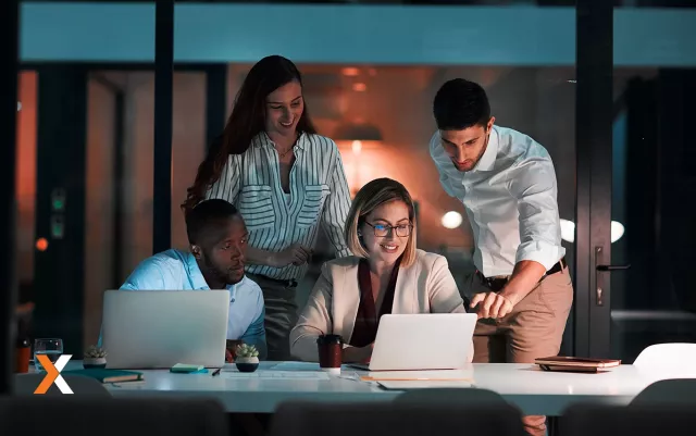 group of business professionals working around laptop